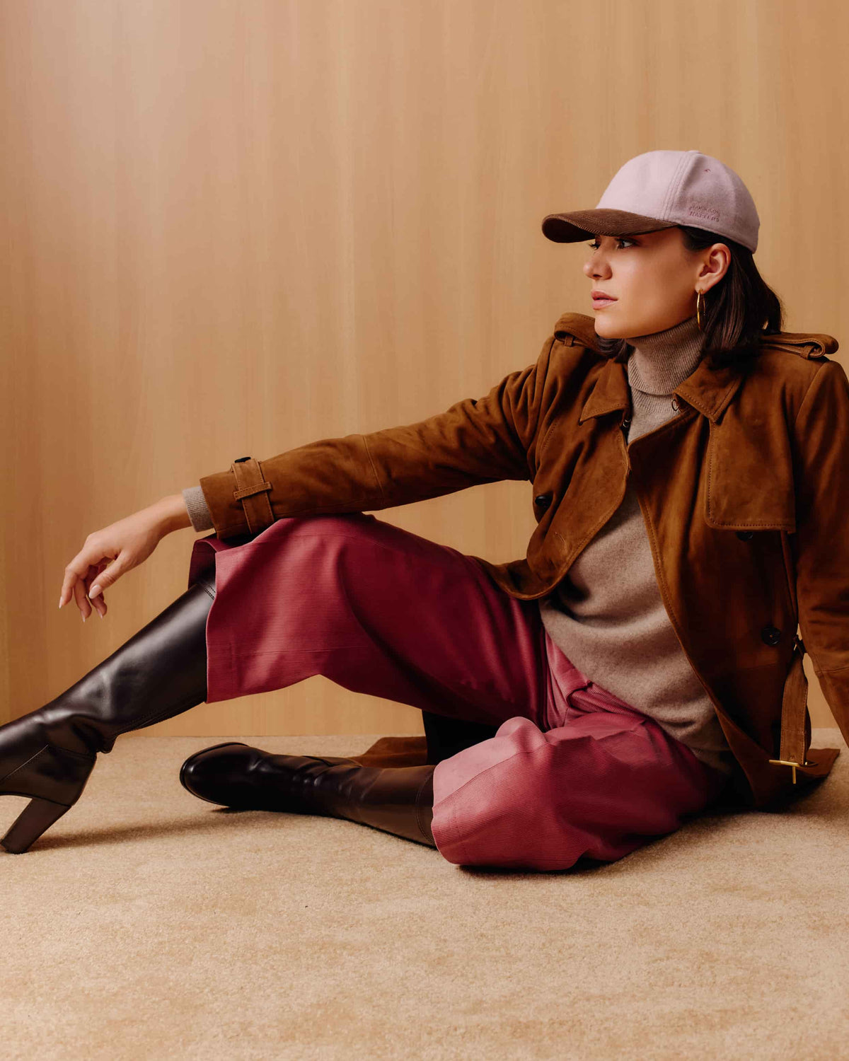 An adjustable baseball cap with a dusty pink cashmere crown and a brown corduroy brim.