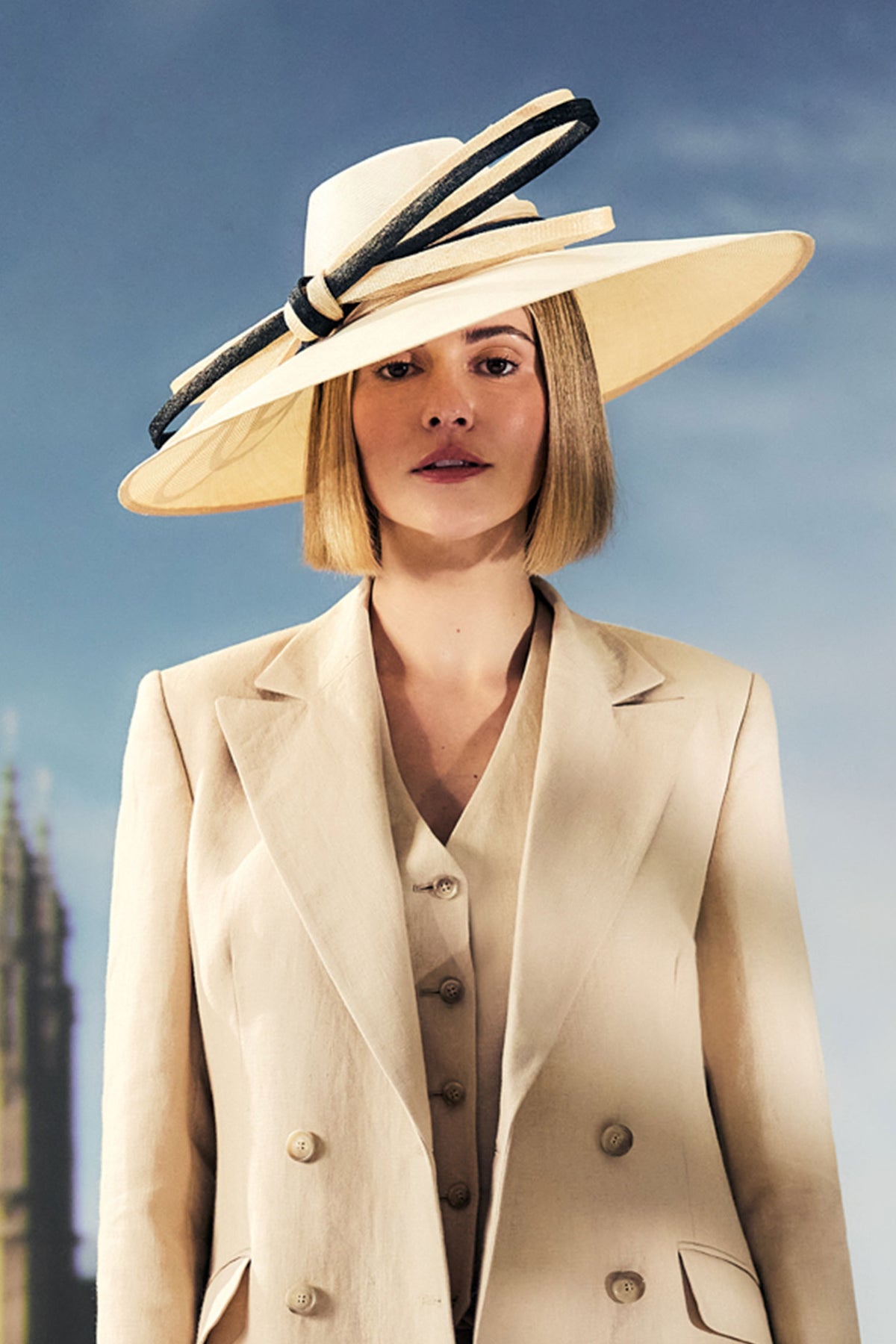 Women's wide brim parabuntal straw fedora hat with a natural and black coloured sinamay bow trim.