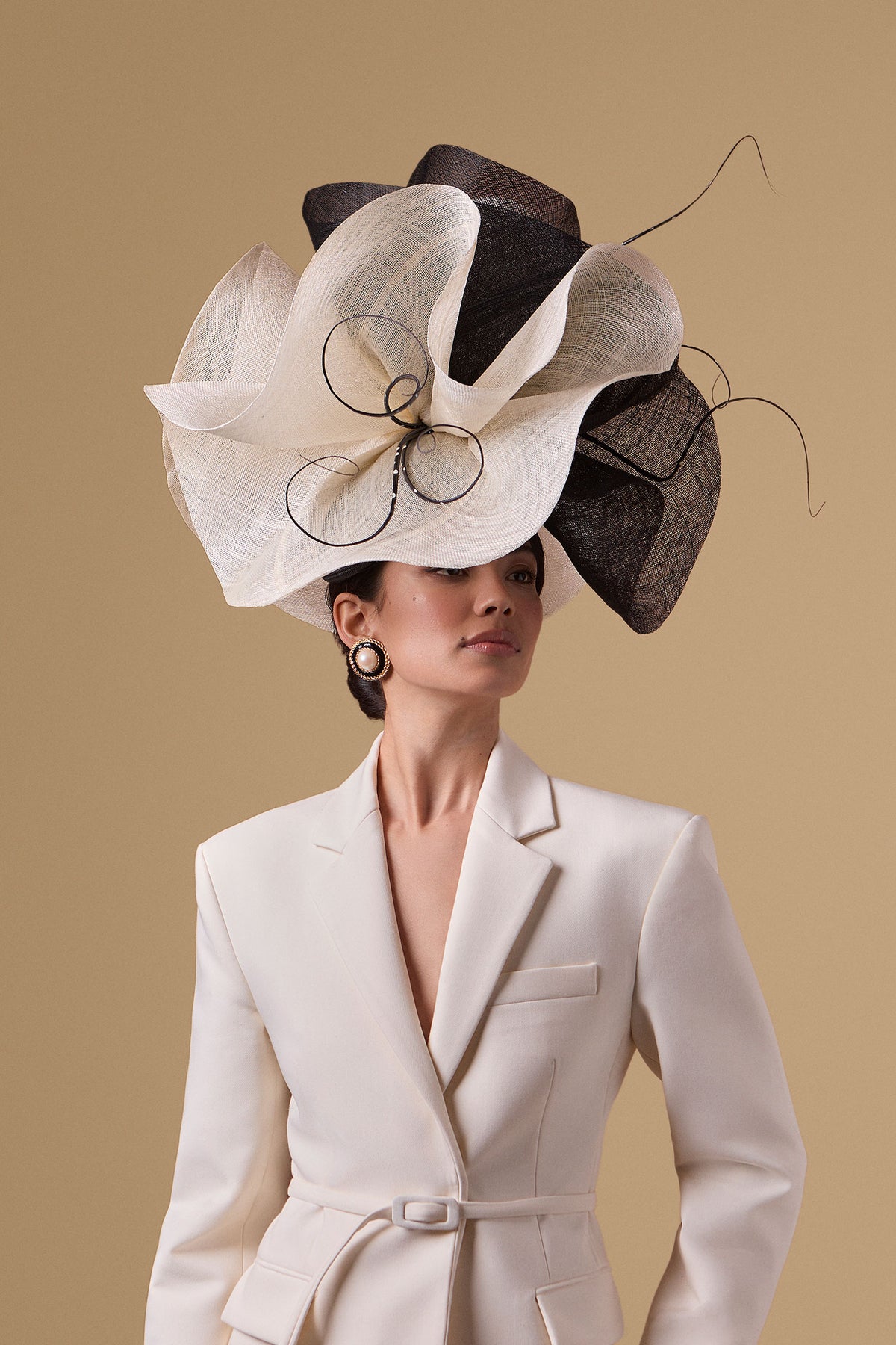 Oversized black and white teardrop percher in parasisal straw with oversized sinamay flowers and artfully sculpted polka dot ostrich quills