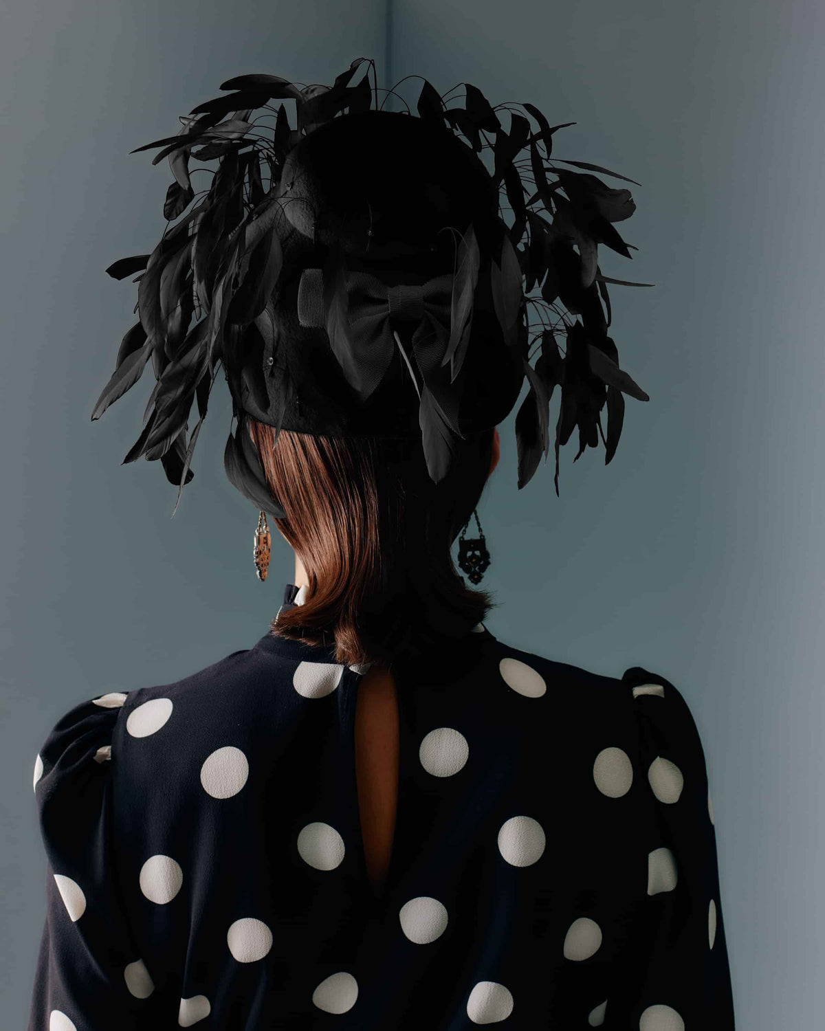 Couture black velour felt beehive shape headpiece with black feathers.