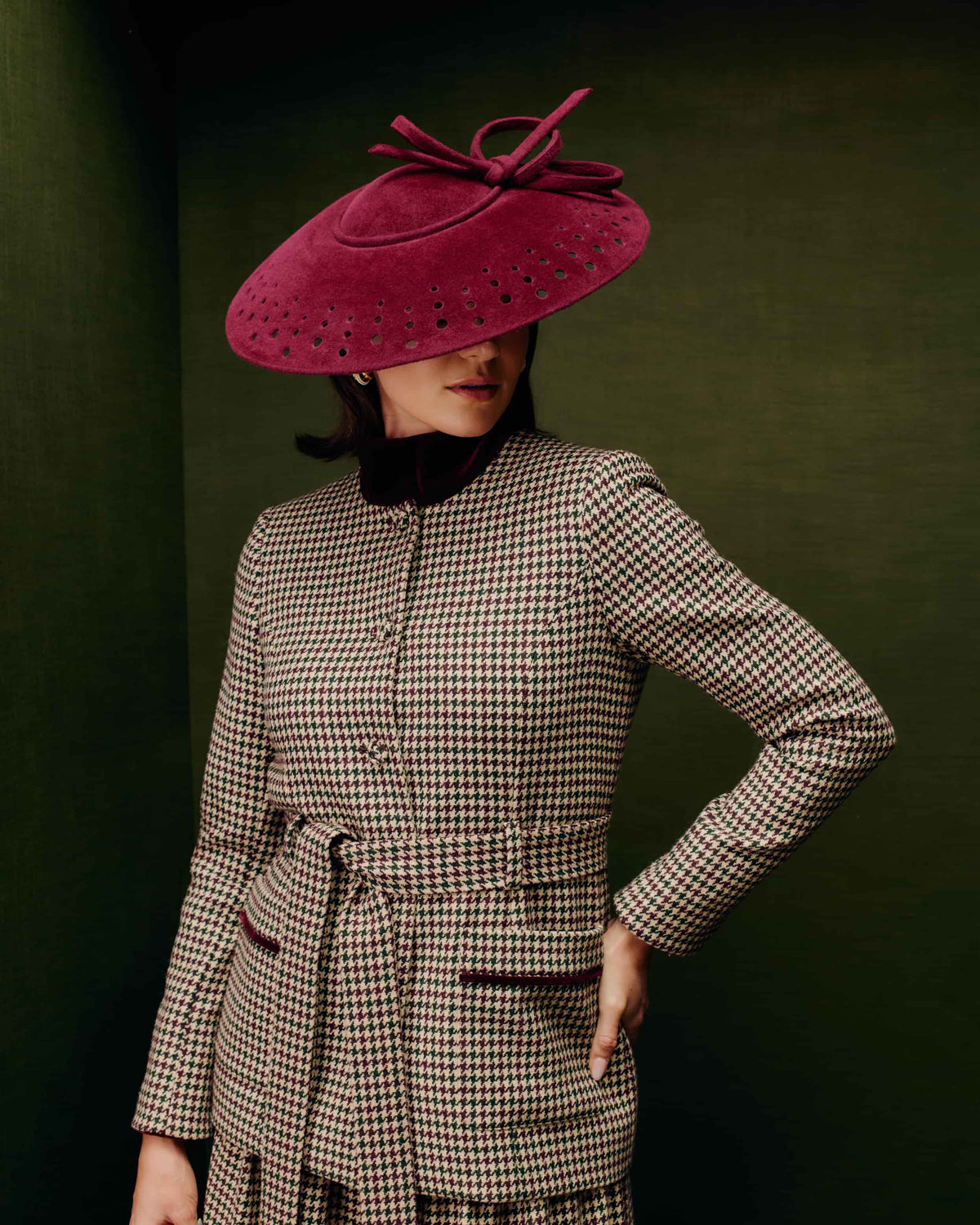 Couture burgundy velour felt saucer hat with punched holes on the brim and a matching bow on top