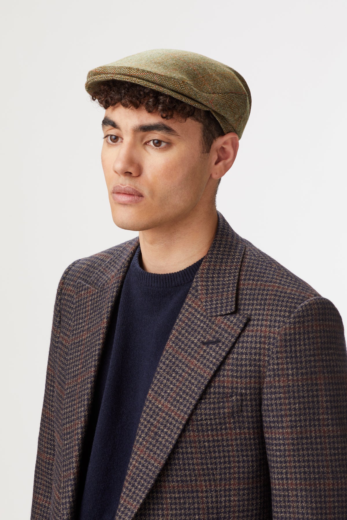 OLIVE GREEN TWEED FLAT CAP WITH INTERNAL EAR FLAPS