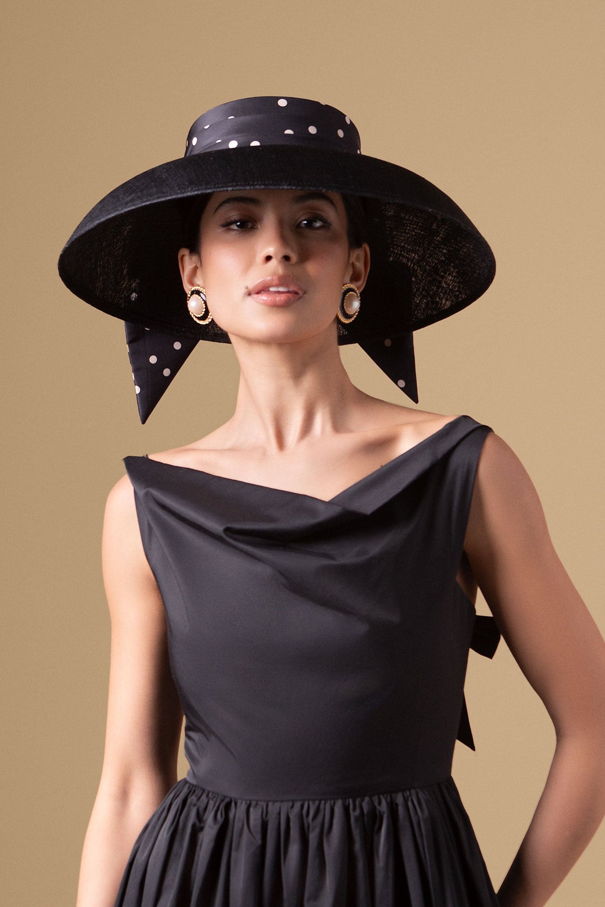 Black sinamay drop brim hat with a silk taffeta polka dot puggery trimband and bow