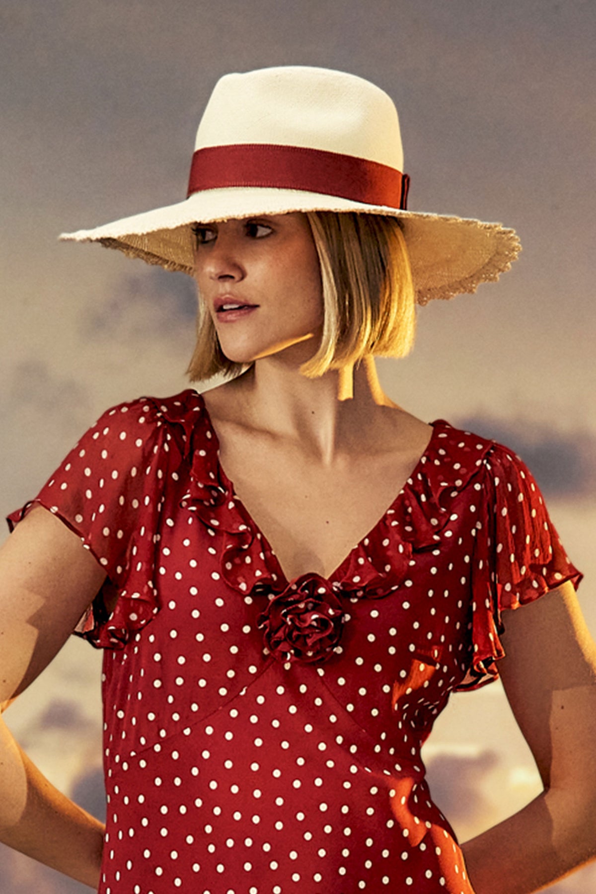 Women's scalloped edge natural straw Panama hat with a dark red ribbon