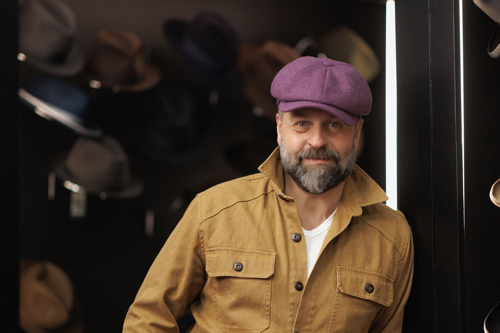 Alfie Boe wearing a Lock & Co. Hatters purple newsboy wool cap.