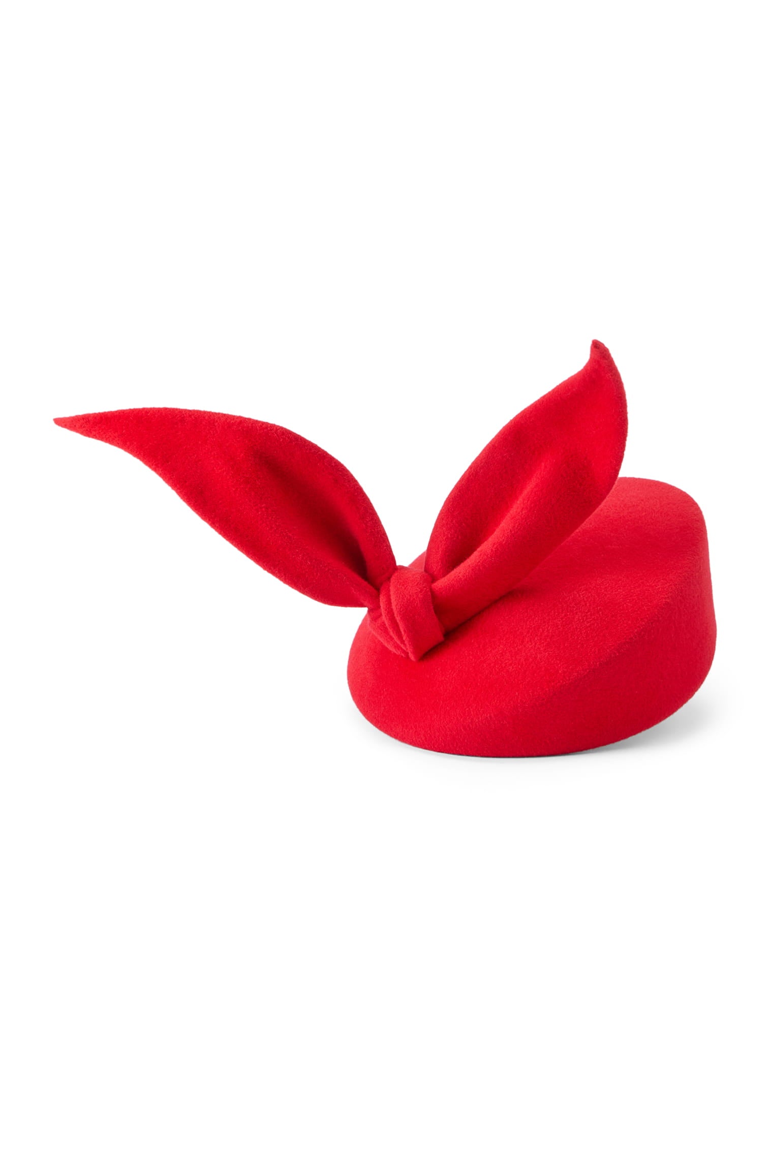 Couture red velour felt percher hat with a rounded base and a sculptural bow at the top.