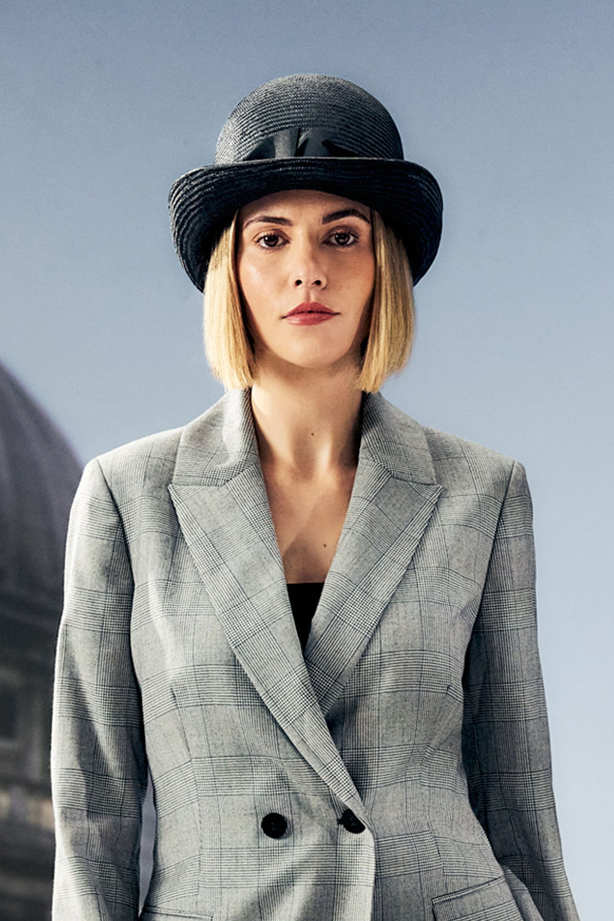 Women's black parasisal bowler hat with a trim band composed of multiple petersham bows.