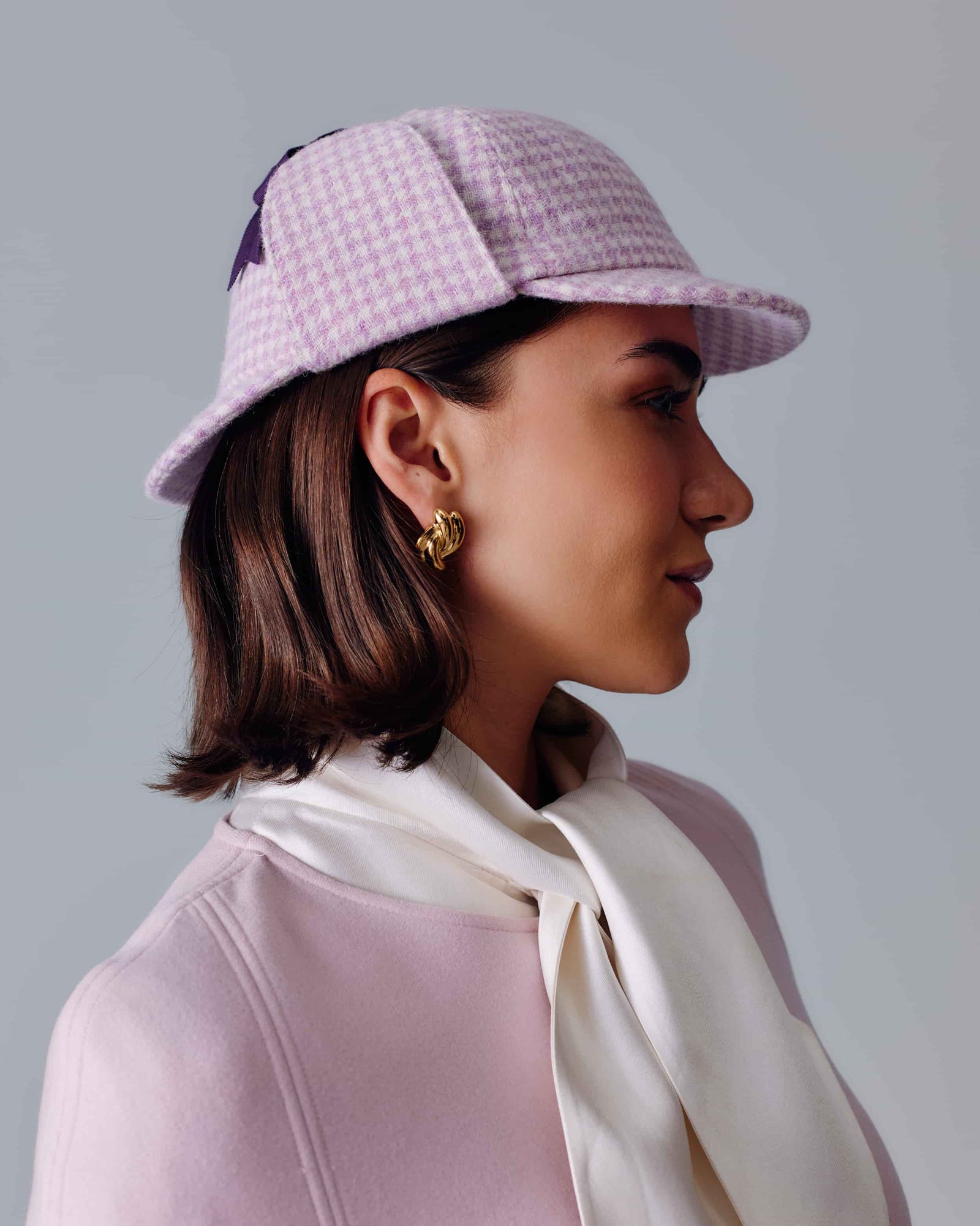 CHECKED PINK & WHITE WOOL TWEED DEERSTALKER HAT WITH EAR FLAPS AND A DARK PURPLE GROSGRAIN RIBBON AND BOW
