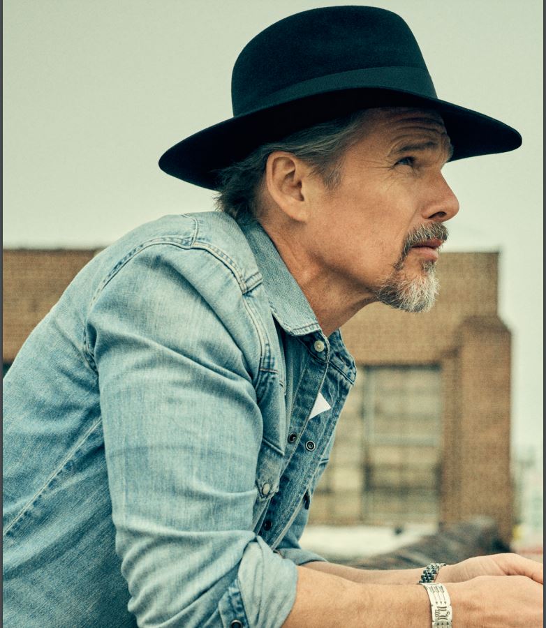 Ethan Hawke in profile wearing a Lock & Co. black wide-brim hat.