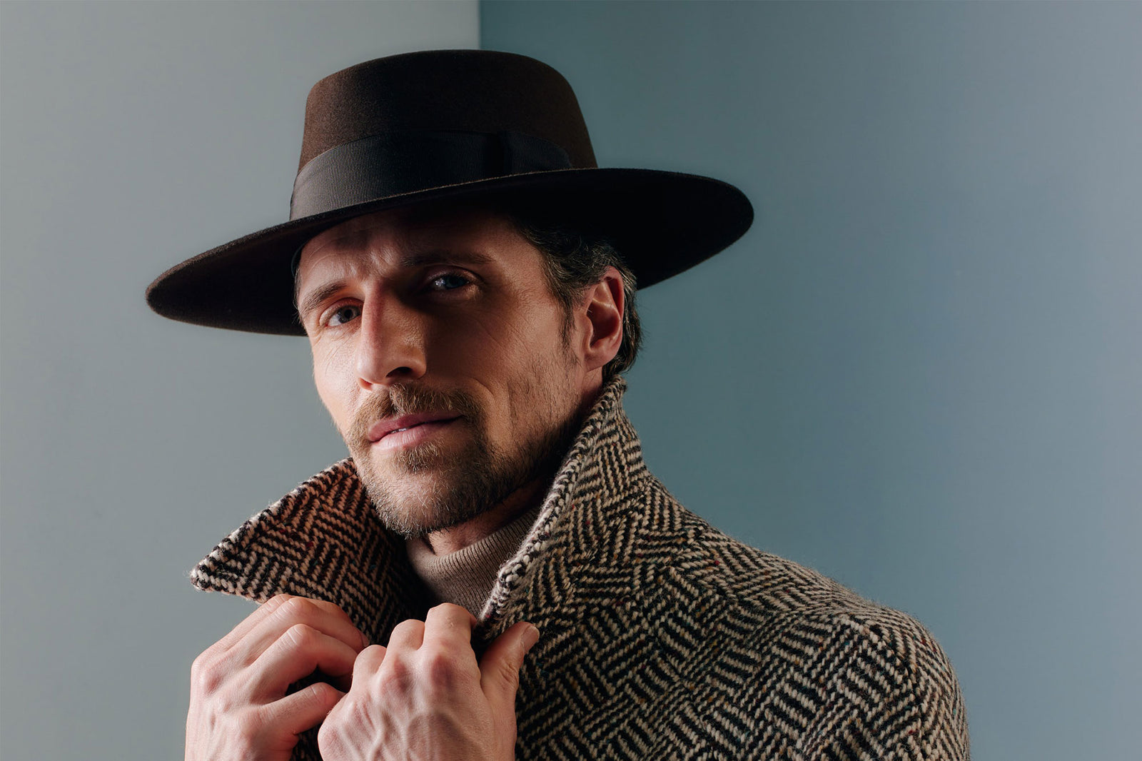 Unisex brown fedora hat with a brown band and bow.