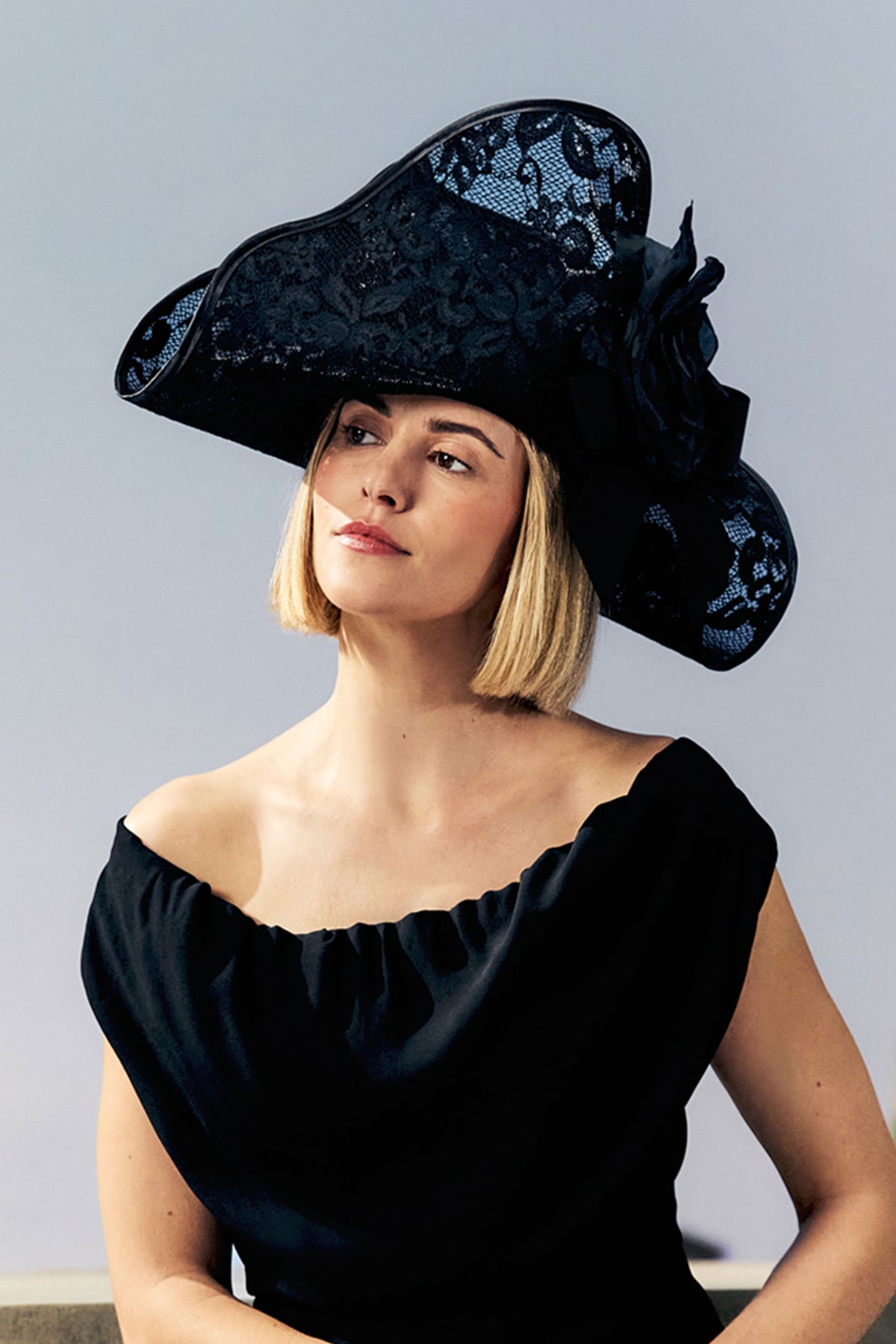 Women's black lace-overlaid bicorn hat with a galloon bow and silk rose