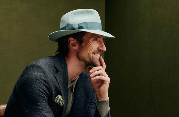 Unisex sage green rabbit fur felt trilby hat with a teal green band and bow.