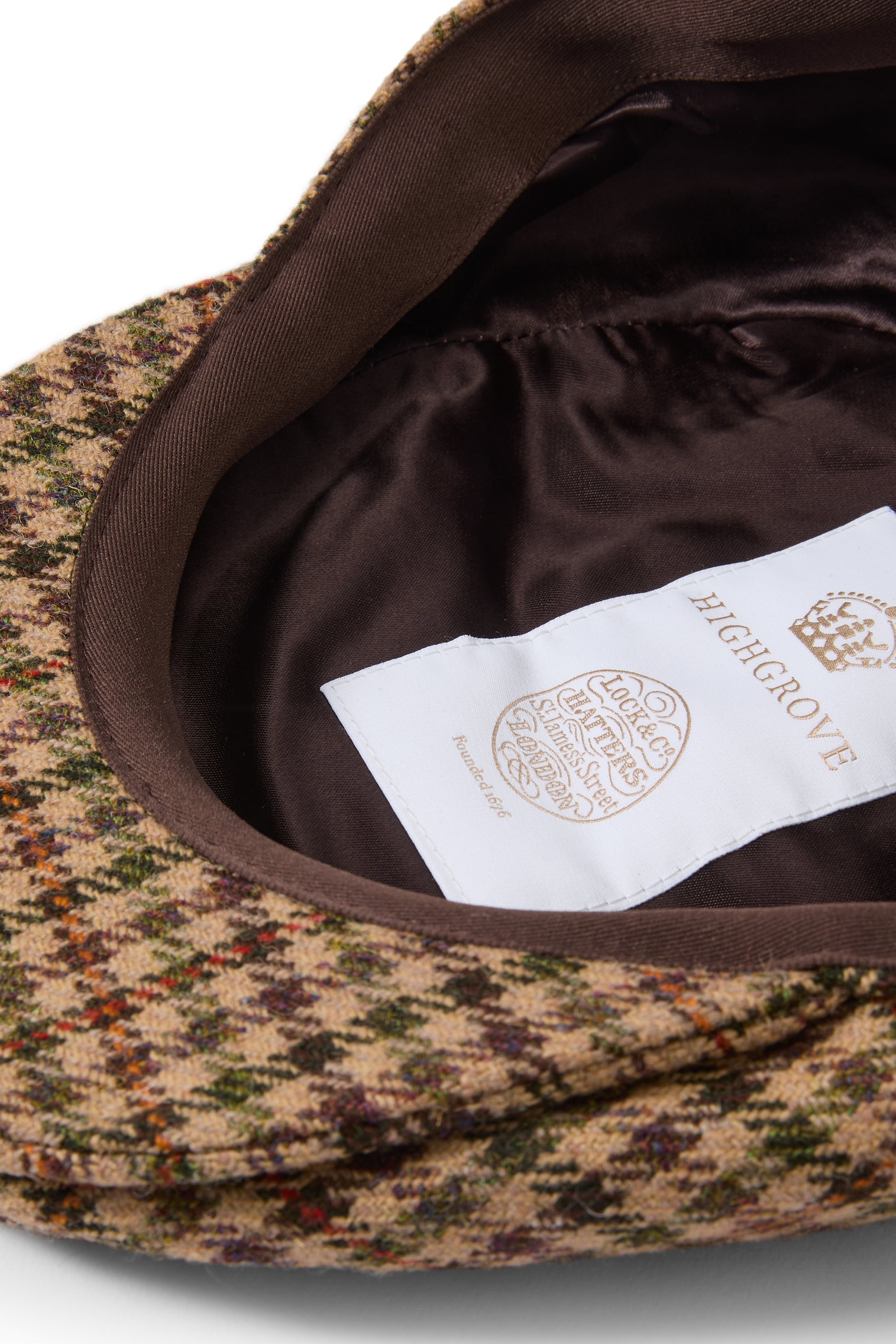 INSIDE OF BROWN, ORANGE AND GREEN CHECK WOOL TWEED FLAT CAP WITH HIGHGROVE LABEL