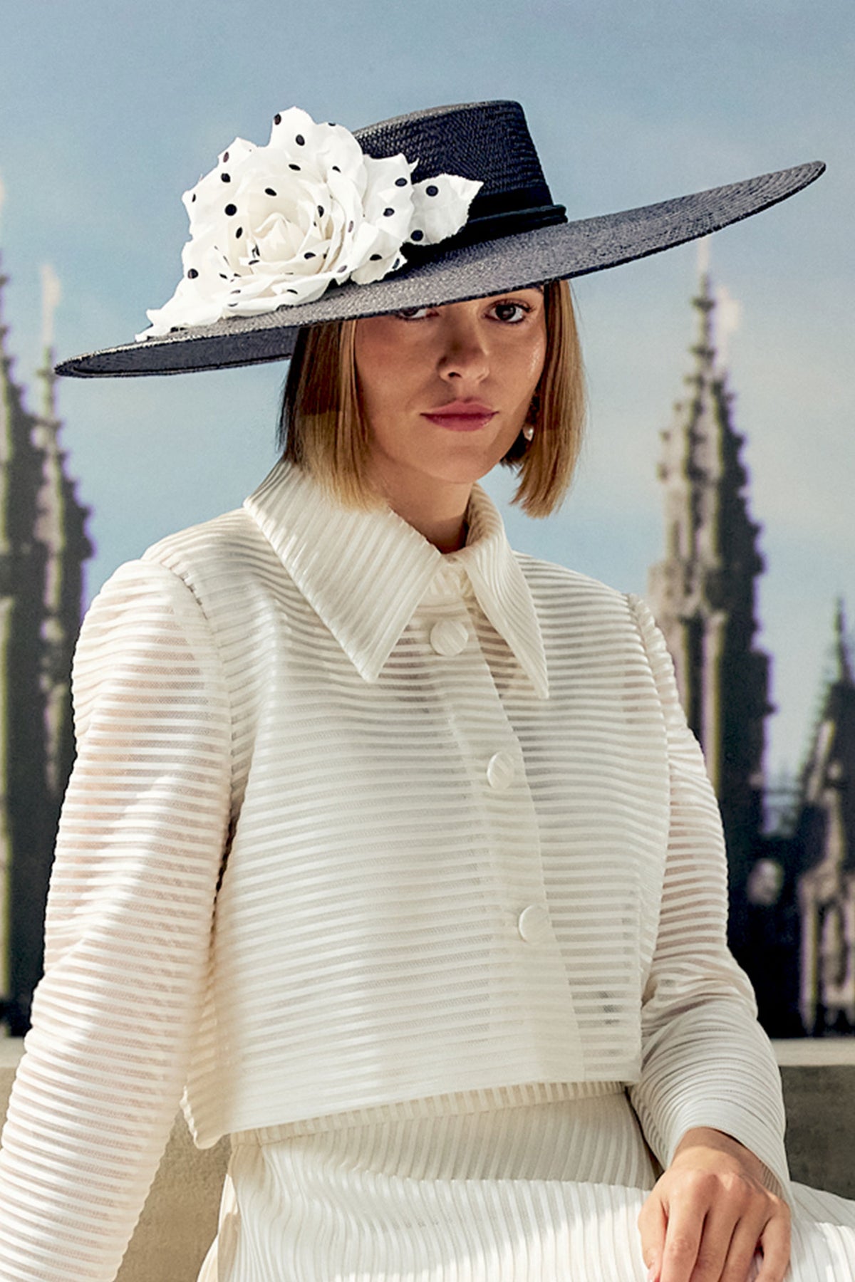 Women's black wide brim Panama straw boater with a classic petersham ribbon, a tasseled rope detail and a contrasting oversized white and black silk polka-dot rose.
