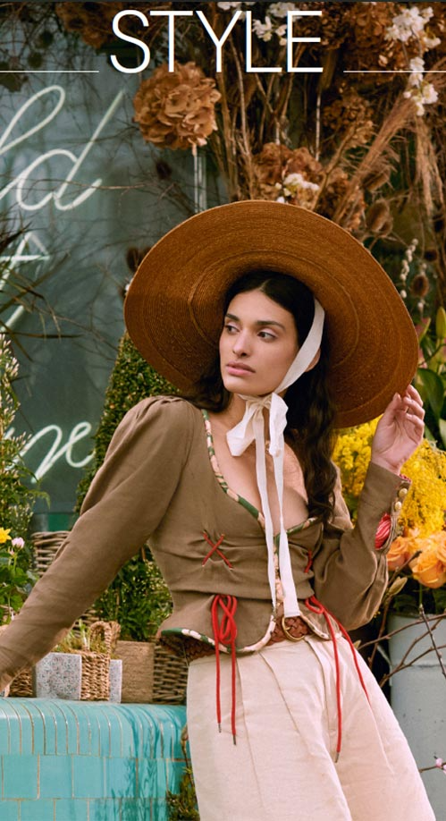 A woman wearing a Lock & Co. wide-brimmed straw hat