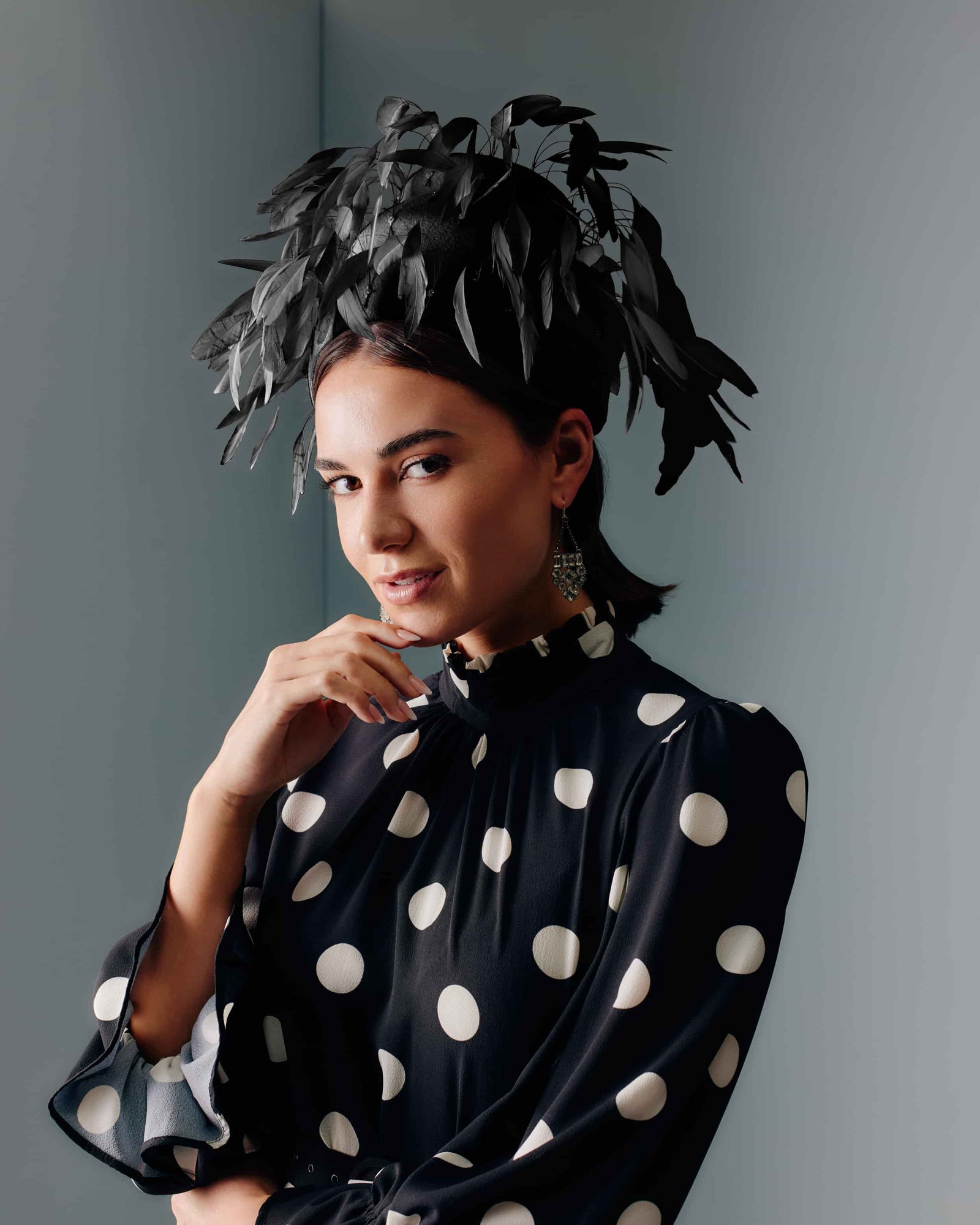 Couture black velour felt beehive shape headpiece with black feathers.