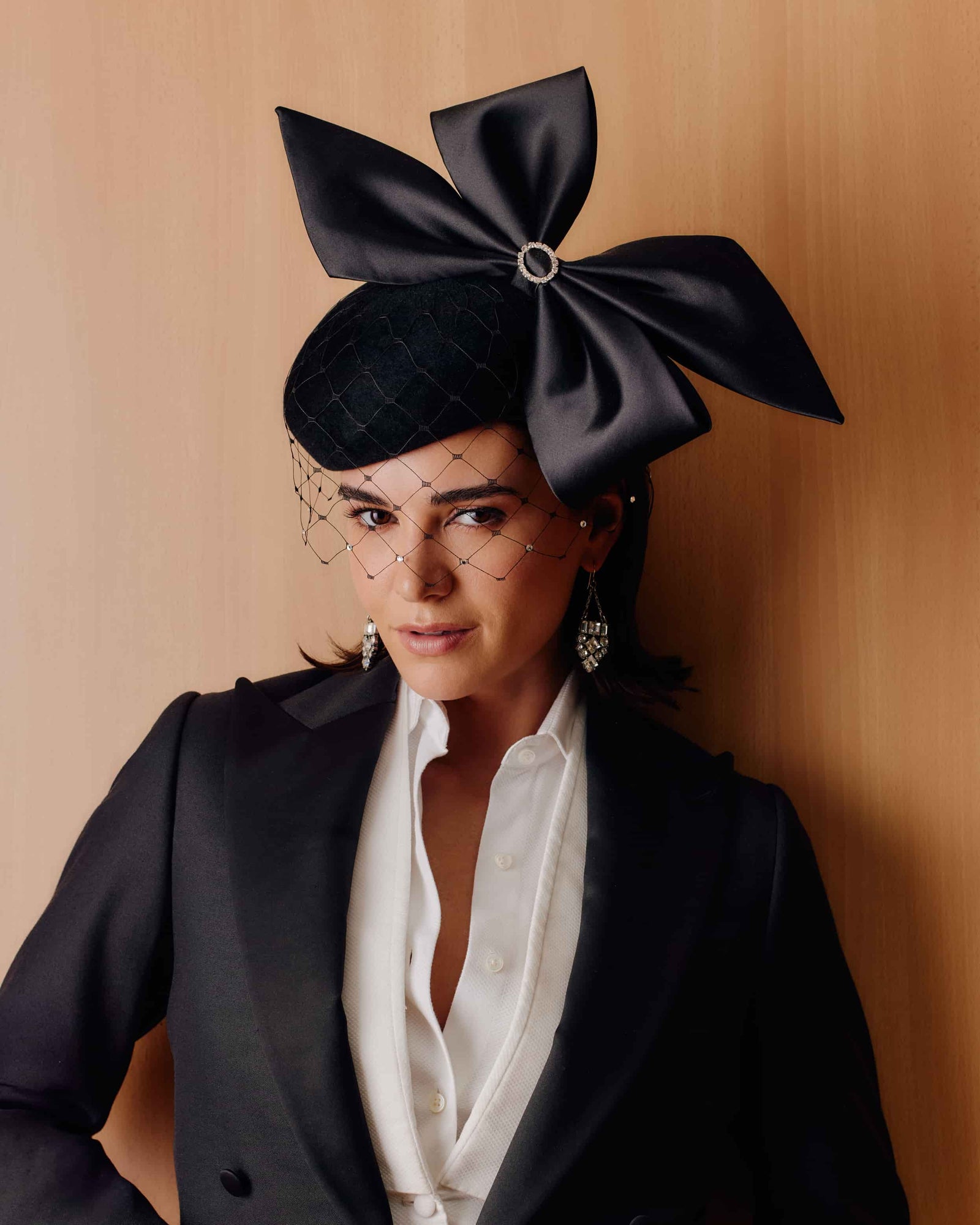 Couture black velour felt beret featuring a large satin bow on top, with a matching crystallised veil.
