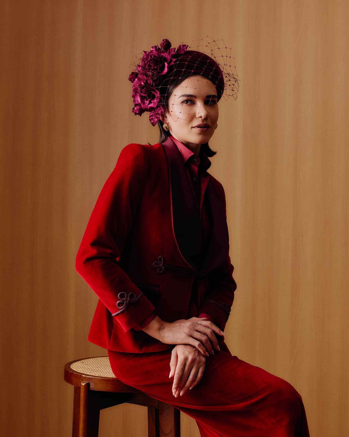 Couture burgundy velvet headband decorated with matching velvet roses and leaves, featuring a matching burgundy veil