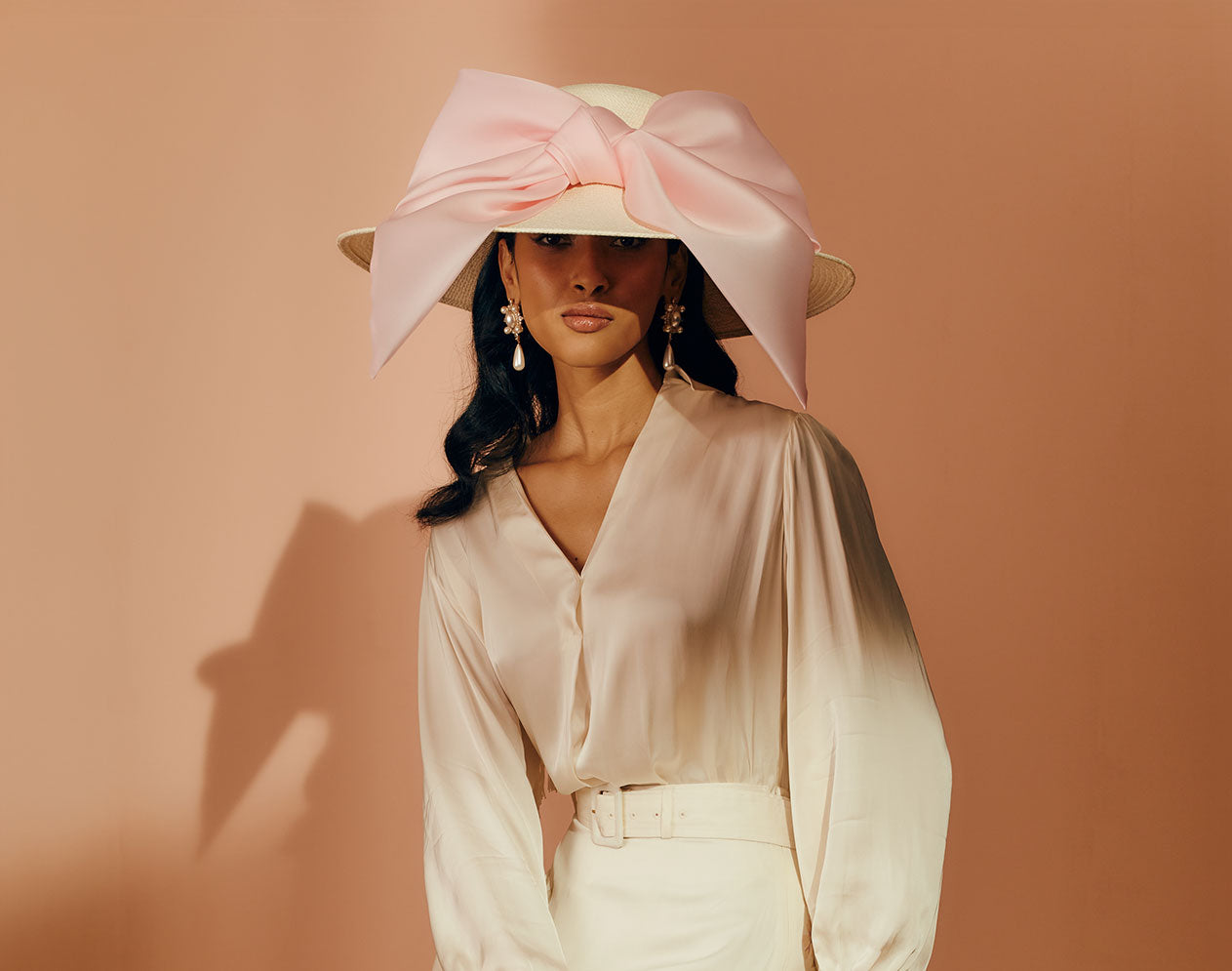 Ivory Panama straw wide-brim picture hat with an oversized silk gazor light pink bow