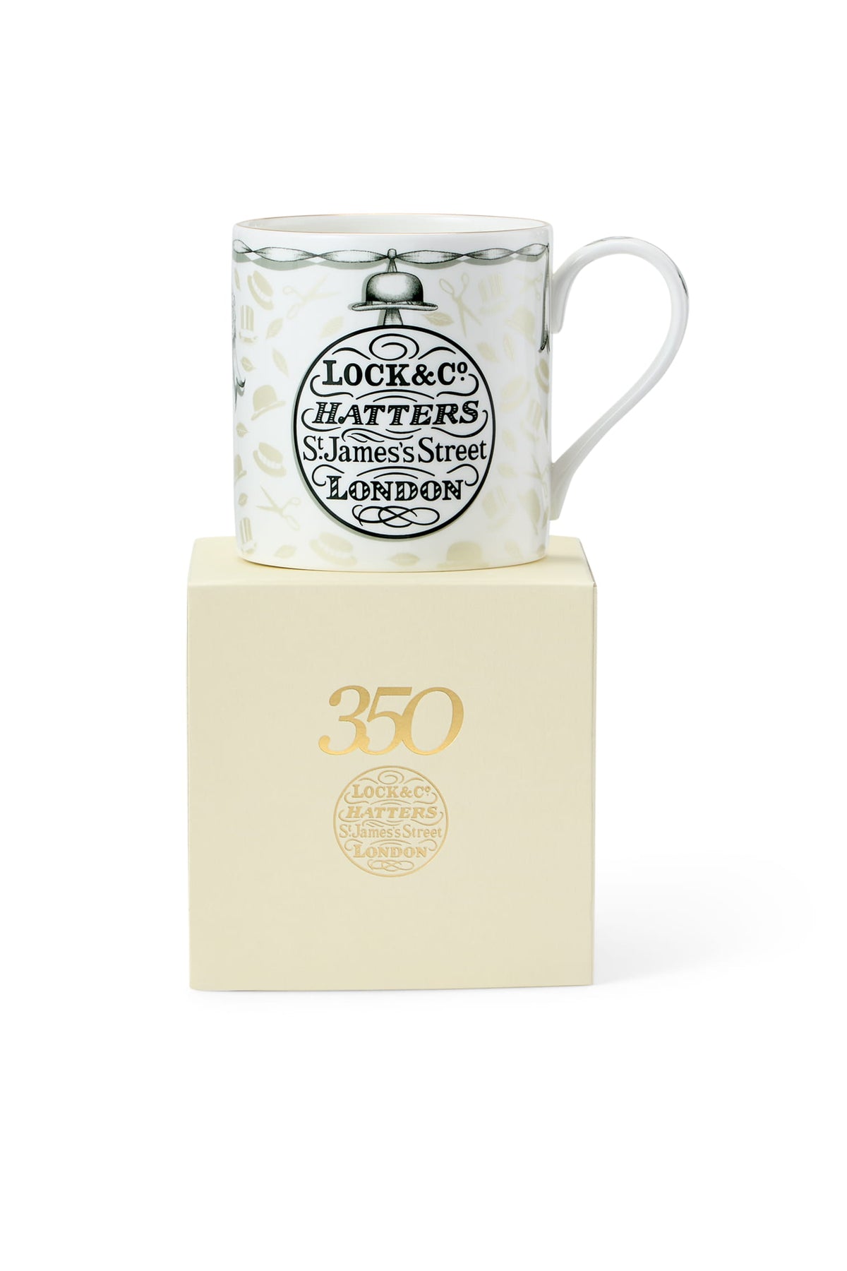 White mug with black logo on a beige box, featuring 'Lock &amp; Co. Hatters' branding.