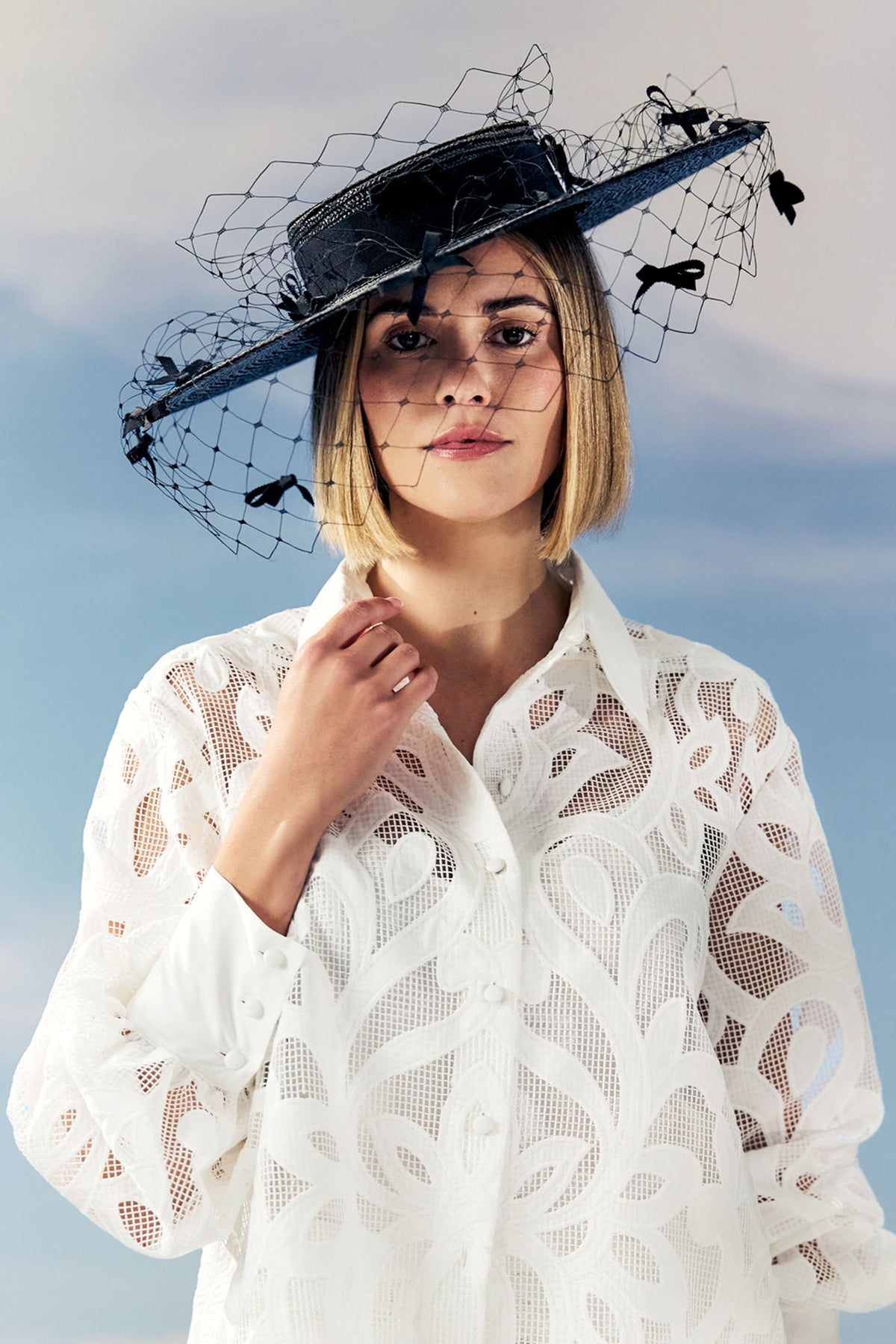 Black pedal straw boater hat with a cotton petersham ribbon and black veiling adorned with miniature bows.