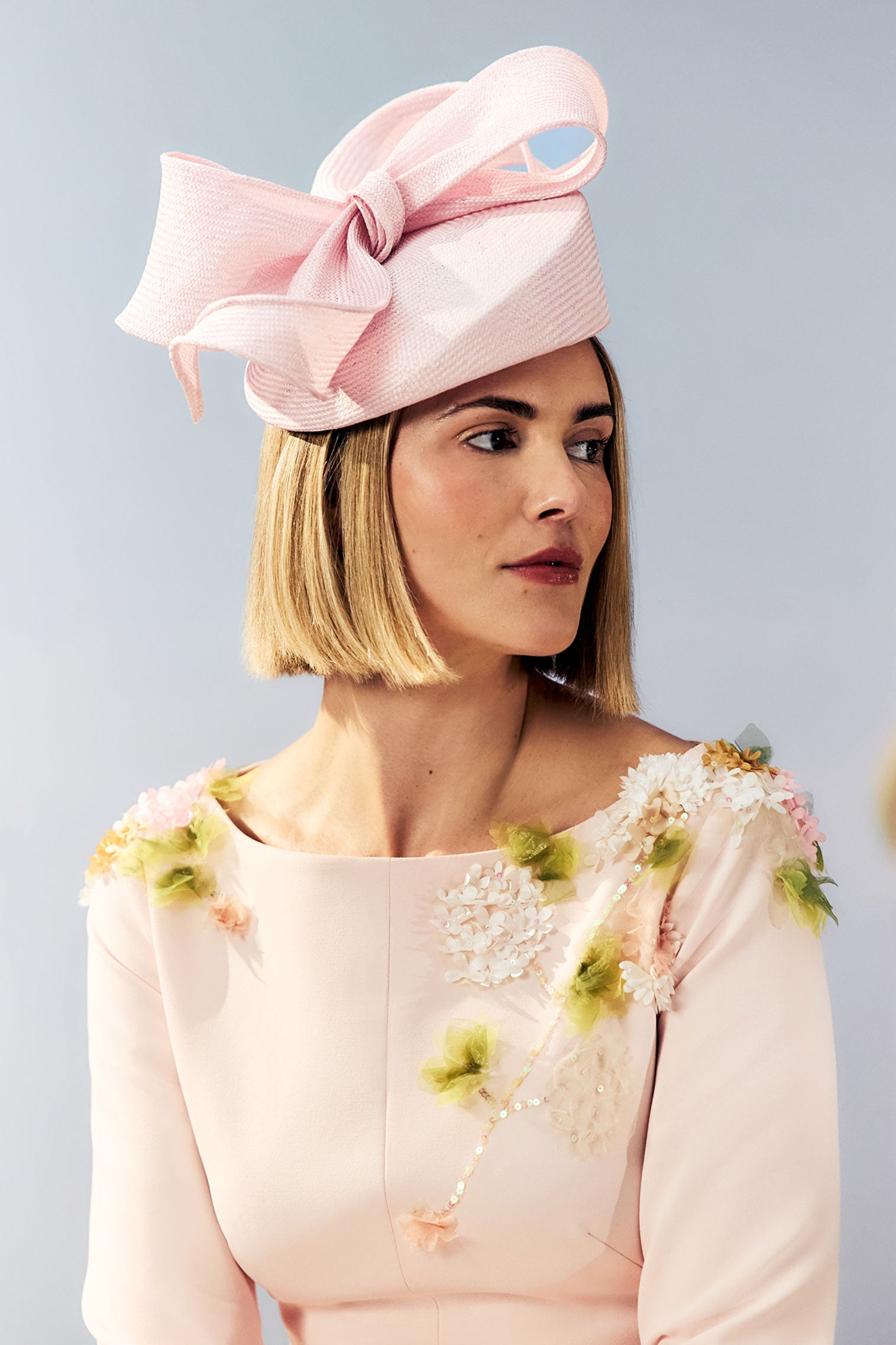 Women's pink parasisal straw pillbox hat with a hand sculpted bow.