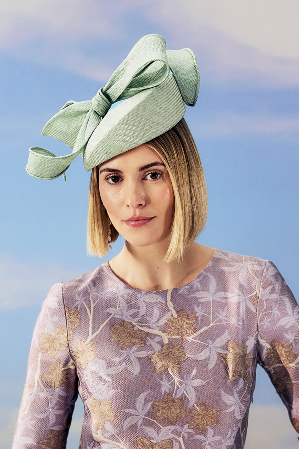 Women's sage green parasisal straw pillbox hat with a hand sculpted bow.