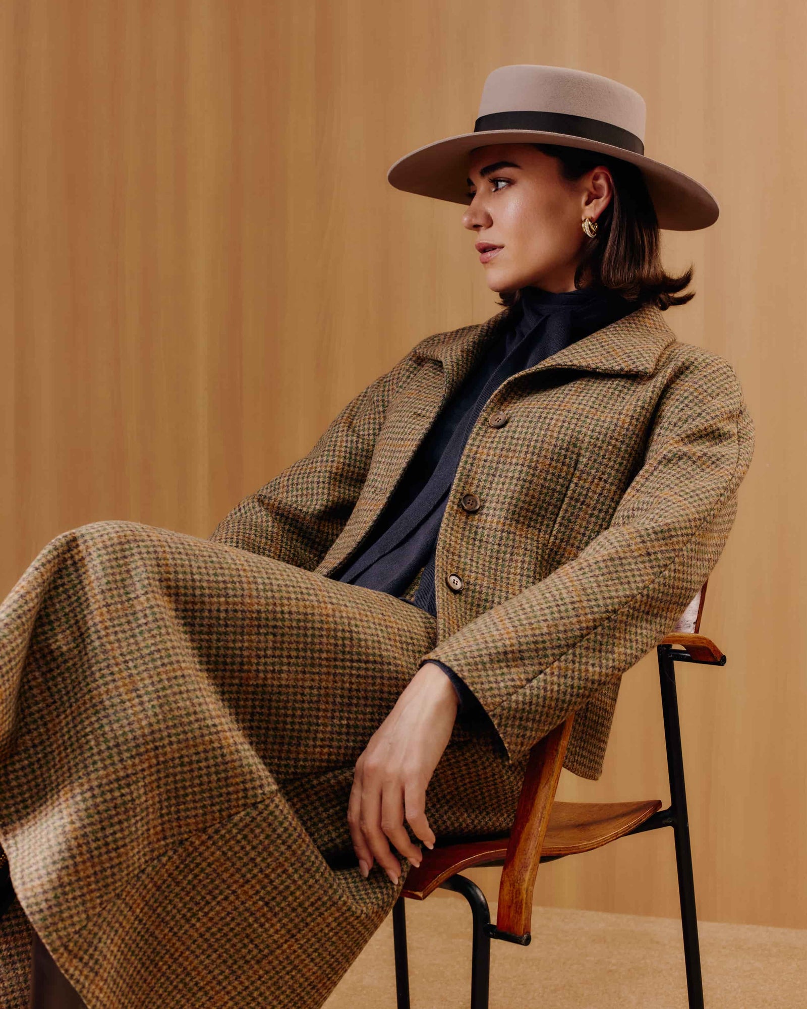 A taupe rabbit fur felt wide-brim boater hat with a brown ribbon band. 