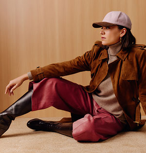 An adjustable baseball cap with a dusty pink cashmere crown and a brown corduroy brim.