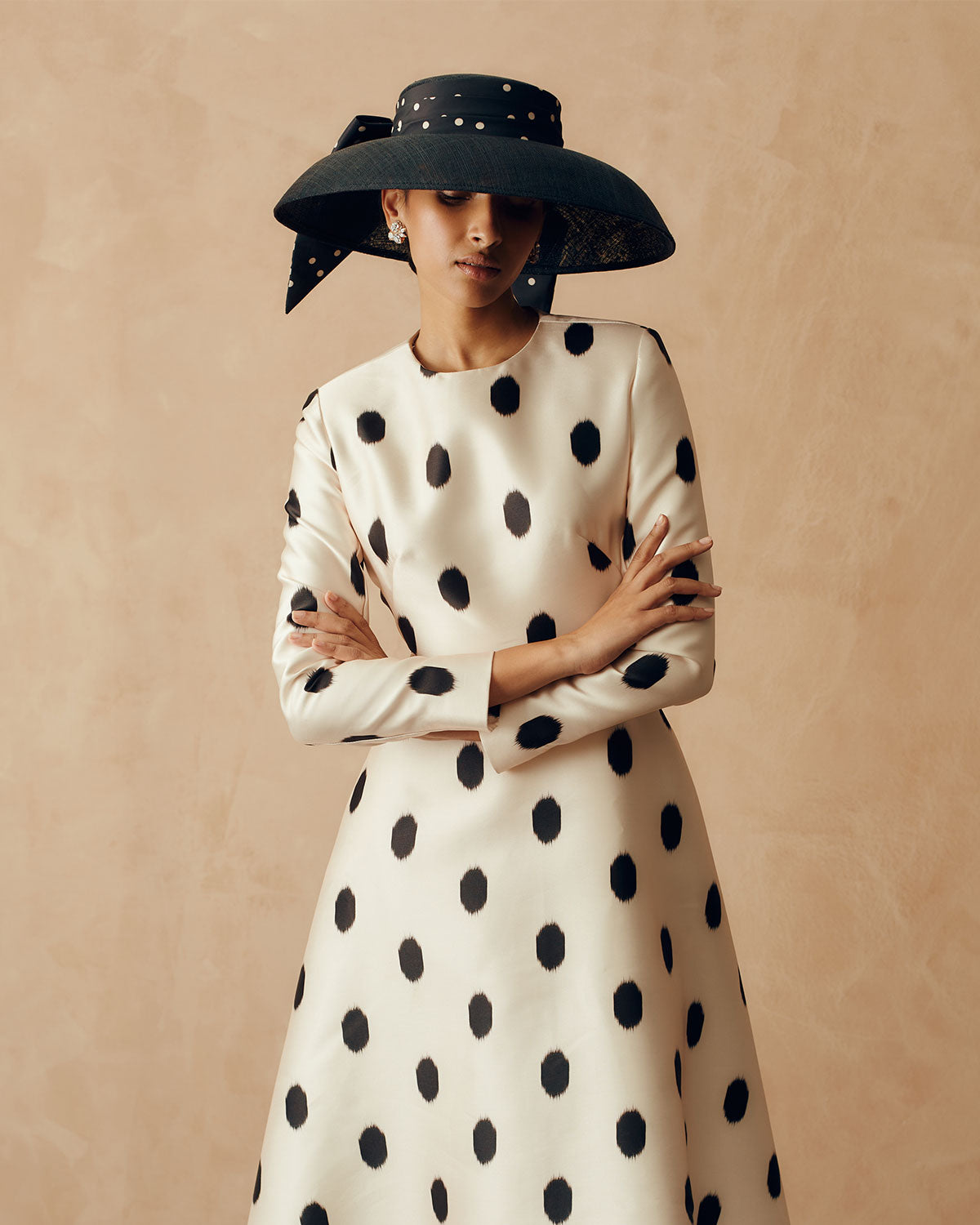 Black sinamay drop brim hat with a silk taffeta polka dot puggery trimband
