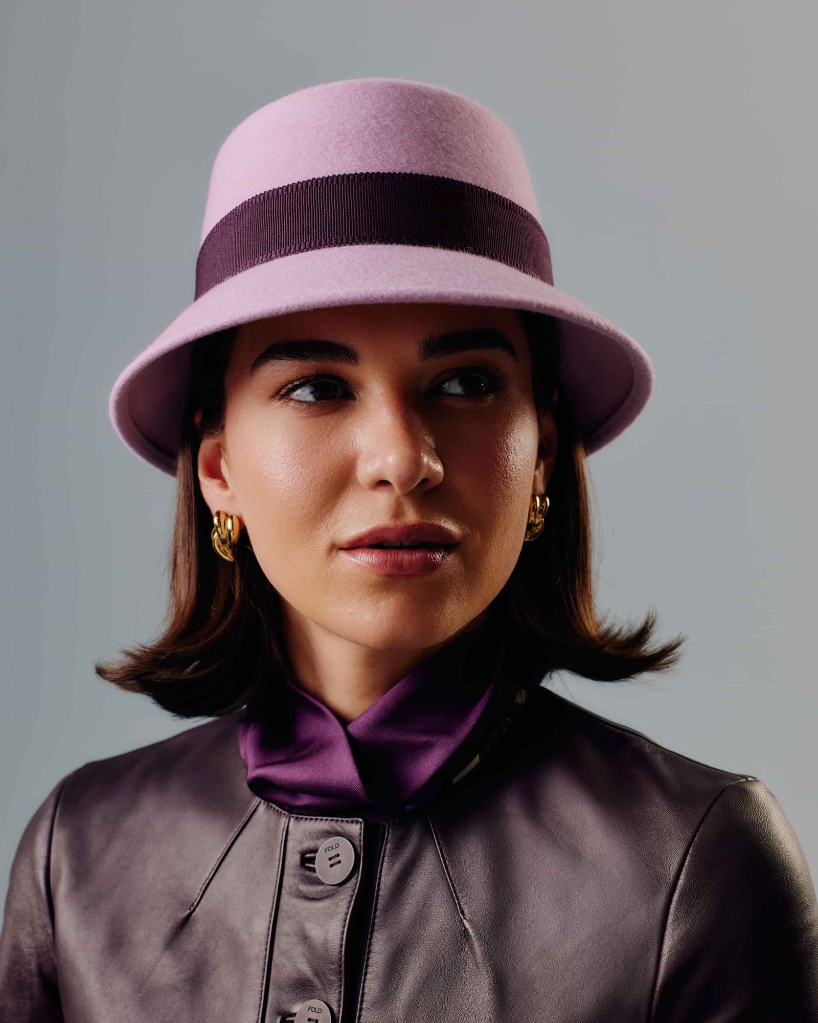 A light pink wool felt hat with a dark burgundy grosgrain ribbon band around the crown.